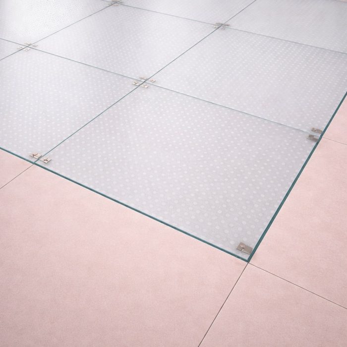 Plancher en verre trempé dépoli (Sablé) de 39 mm orné d'une texture de petits cercles, parfait pour un éclairage d'ambiance raffiné.